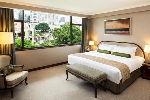 a bedroom with a large bed and a large window at Marco Polo Hongkong Hotel in Hong Kong