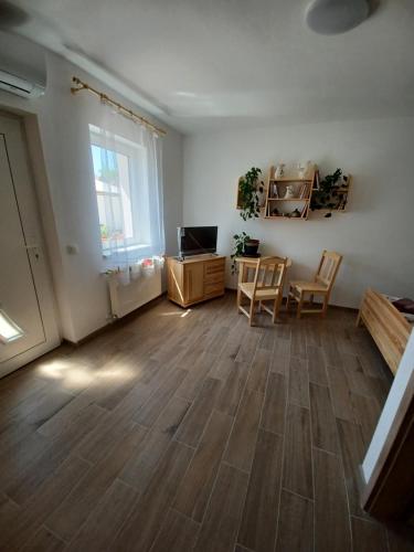 an empty living room with a table and chairs at Fazekas Vendégház in Balatonkeresztúr