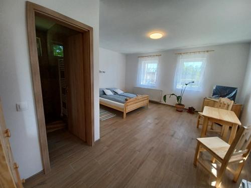 a living room with a bed and a table at Fazekas Vendégház in Balatonkeresztúr