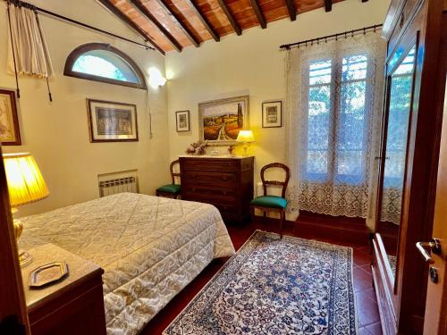a bedroom with a bed and a dresser and a window at Monteriggioni Castello in Monteriggioni