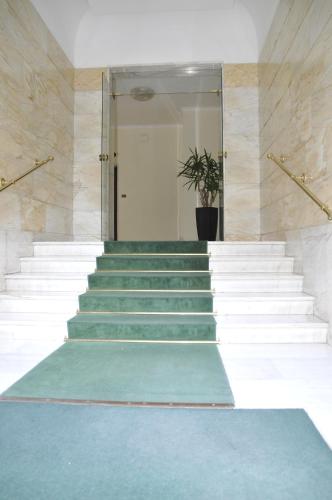 a hallway with stairs with a potted plant in it at Sweet Home Parioli in Rome
