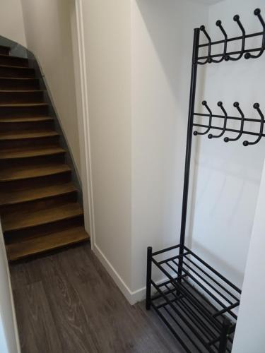 a stairwell with a black metal rail next to a staircase at Appartement Petite Auberge in Saint-Jean-dʼAssé