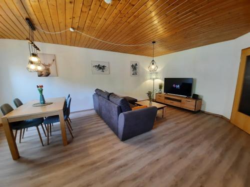 a living room with a couch and a table at Ferienwohnung-Einklang im schönen Südschwarzwald in Todtnau