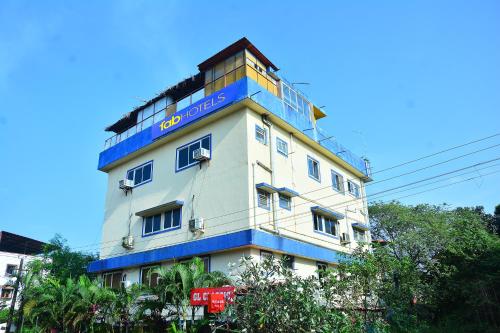 un edificio blanco y azul con un cartel en él en FabExpress GL Classic With Bar, Porvorim, en Old Goa