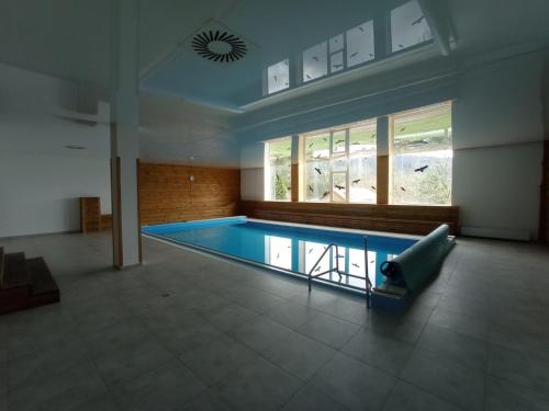 a large room with a pool in a house at Hotel Kristian in Kubova Huť