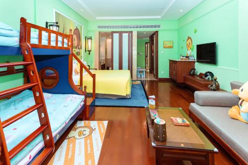 a bedroom with bunk beds and a living room with a couch at InterContinental Xishuangbanna Resort by IHG in Jinghong