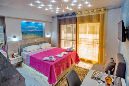 a bedroom with a bed with a pink blanket at RENT HOUSE ANEMOS in Iraklitsa