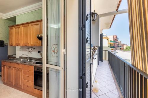a kitchen with a view of a balcony at House&Villas - Marina Holiday in Avola