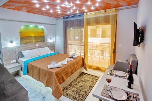 a bedroom with a bed and a balcony at RENT HOUSE ANEMOS in Iraklitsa