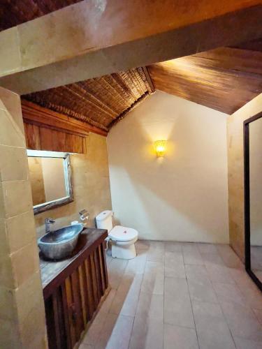 a bathroom with a sink and a toilet at Samba Villas Beachfront View in Gili Trawangan