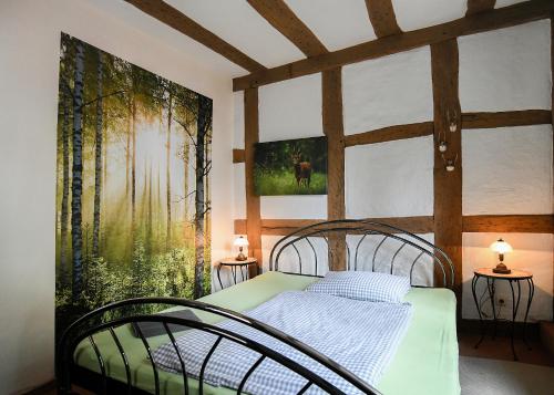 um quarto com uma cama e um quadro na parede em Burgmannenhaus em Steinau an der Straße