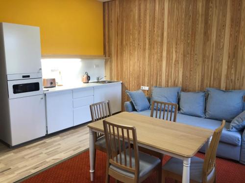 a living room with a table and a blue couch at DNM Inn in Koryčany
