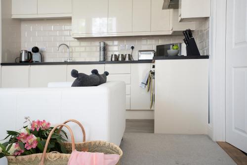 a kitchen with white cabinets and a sink at Ipswich Town Centre - Apartment 7 in Ipswich