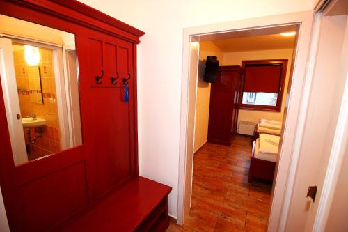 a room with a red door and a bathroom at ZELENÝ SKLEP in Dolní Dunajovice