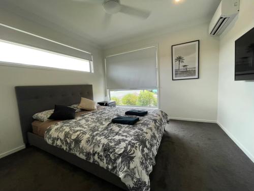 a bedroom with a bed and a large window at Family Holiday Vibe House in Dakabin in Dakabin