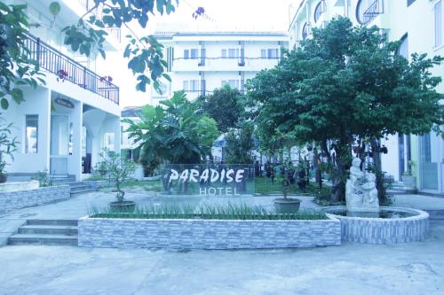 a hotel sign in front of a building at Paradise Hotel in Hoi An