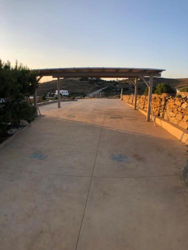 an empty parking lot with a bridge in the background at The Stone Windmill in Koundouros
