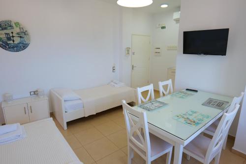 a room with a bed and a table and chairs at Hotel Mira Mare in Ksamil