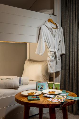a room with a bed and a table with plates of food at North Lakes Hotel and Spa in Penrith