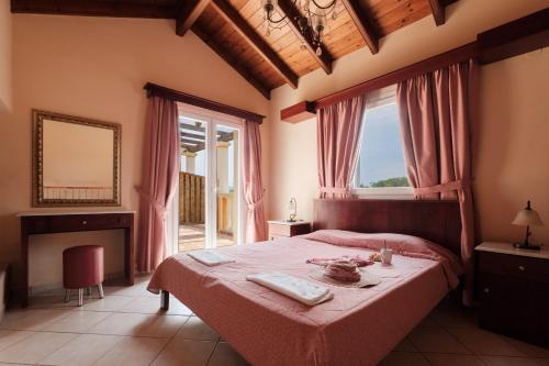 a bedroom with a bed and a large window at Ballas Paradise in Roda
