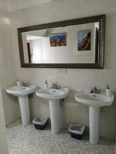 a bathroom with two sinks and a mirror at Casa rural Ardetxal a 16km de Logroño y Laguardia in Viñaspre