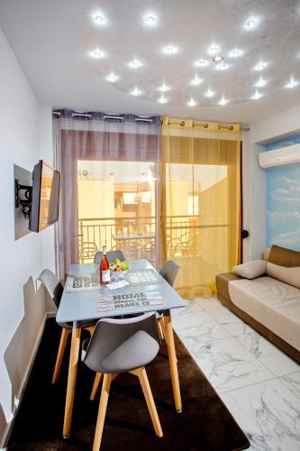 a living room with a table and chairs and a couch at RENT HOUSE ANEMOS in Iraklitsa