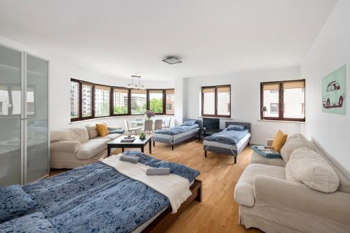 a living room with a bed and a couch at Waw pokoje Wilanów in Warsaw