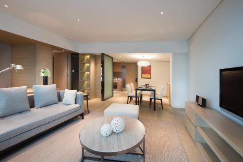 a living room with a couch and a table at Marco Polo Wuhan in Wuhan