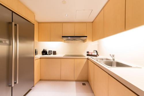 a kitchen with wooden cabinets and a sink at Marco Polo Wuhan in Wuhan