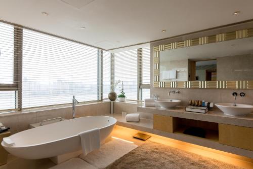 a large bathroom with two sinks and a large tub at Marco Polo Wuhan in Wuhan