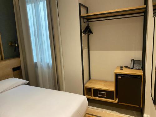 a bedroom with a bed and a mirror and a phone at Fontanella By BCN URBAN Rooms in Barcelona