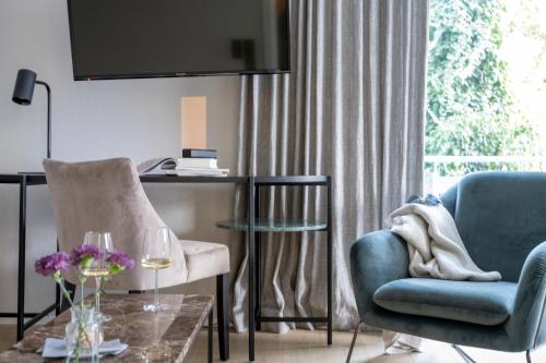 a living room with two chairs and a table at Hotel Garni Villa Rosengarten in Überlingen