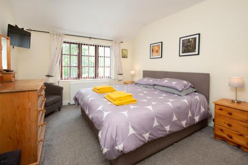 a bedroom with a bed with yellow towels on it at Stable Lofts in York