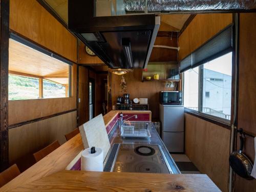 a kitchen with a counter in a tiny house at SUMITSUGU HOUSE East in Kumamoto