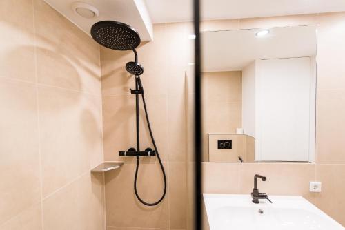 a bathroom with a shower and a sink at Appartement HideAway Nr 96 - Amelander Kaap in Hollum