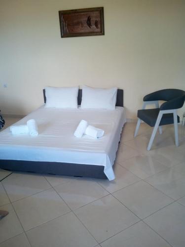 a bed and a chair in a room at villa roses-mourteri in Mourteri