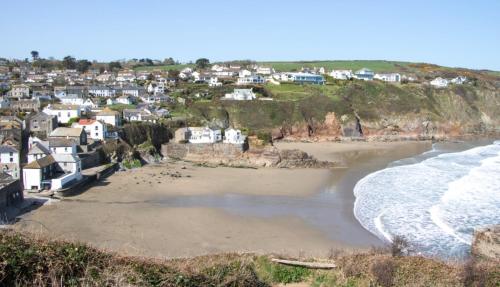a view of a beach with houses and the ocean at SunnyVale Valley View Cottage in Gorran Haven