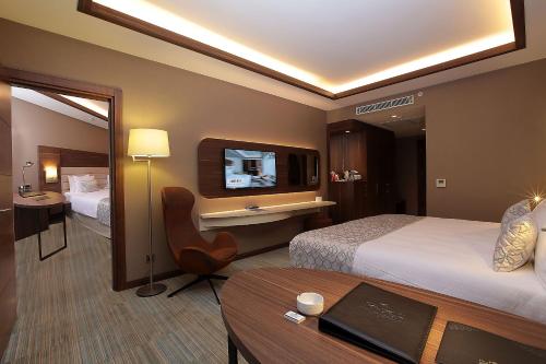 a hotel room with a television and a bed at Bricks Hotel İstanbul in Istanbul