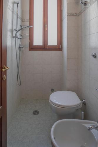 a bathroom with a toilet and a sink at Appartamento Lungomare - HelloElba in Portoferraio