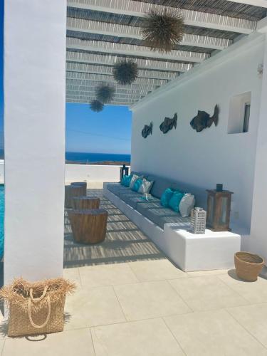 a living room with a couch and a view of the ocean at Lidia Villa in Panormos Mykonos