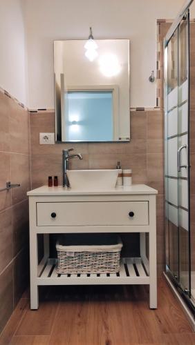 a bathroom with a sink and a mirror at B&B Va' Pensiero in Villasimius