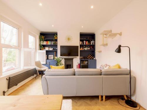 a living room with a couch and a tv at Garden Walthamstow Apartment Pass the Keys in London