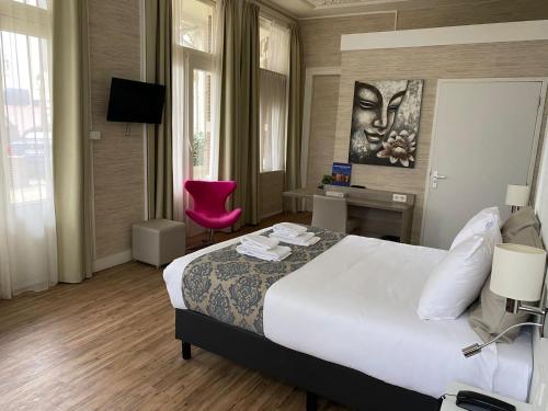 En eller flere senge i et værelse på Hotel Andante aan Zee