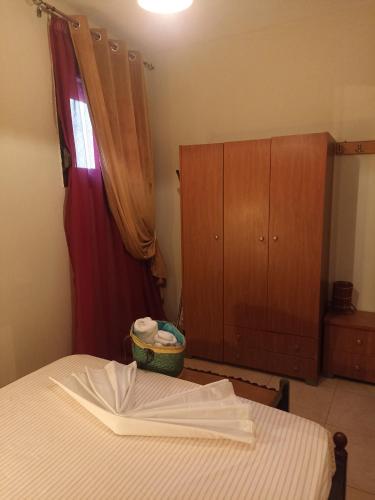 a bedroom with a bed and a dresser and a cabinet at ΠΛΑΤΕΙΑ-PLATIA in Ayios Nikolaos Sithonia