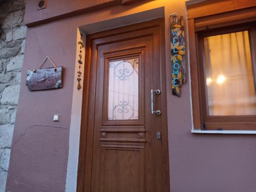 a wooden door on the side of a building at ΠΛΑΤΕΙΑ-PLATIA in Ayios Nikolaos Sithonia