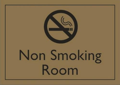 a sign that says non smoking room with a no smoking sign at Sukhumvit Suites Hotel in Bangkok