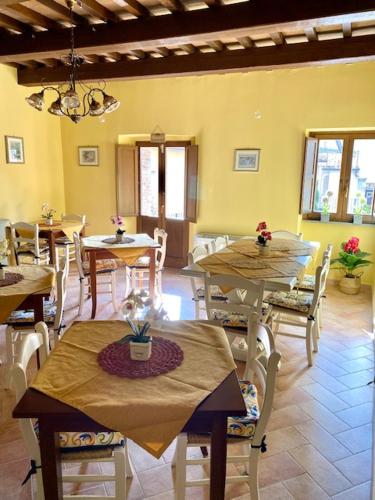 a dining room with tables and chairs in a building at Albergo La Loggia di San Martino in Gualdo Tadino