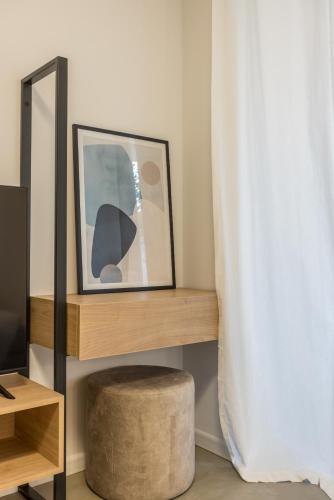 a room with a shelf with a picture and a stool at PORTO SERENO apartments in Šibenik
