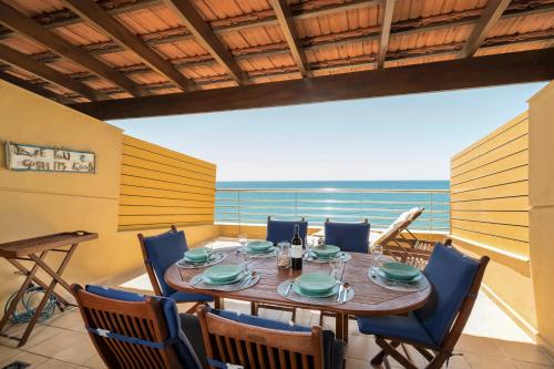 ein Esszimmer mit Tisch und Stühlen und dem Meer in der Unterkunft MEDANO4YOU The Ocean House in El Médano
