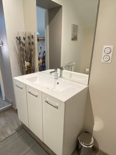 W łazience znajduje się biała umywalka i lustro. w obiekcie Chambre privative chez Toutoune w mieście Fontainebrux